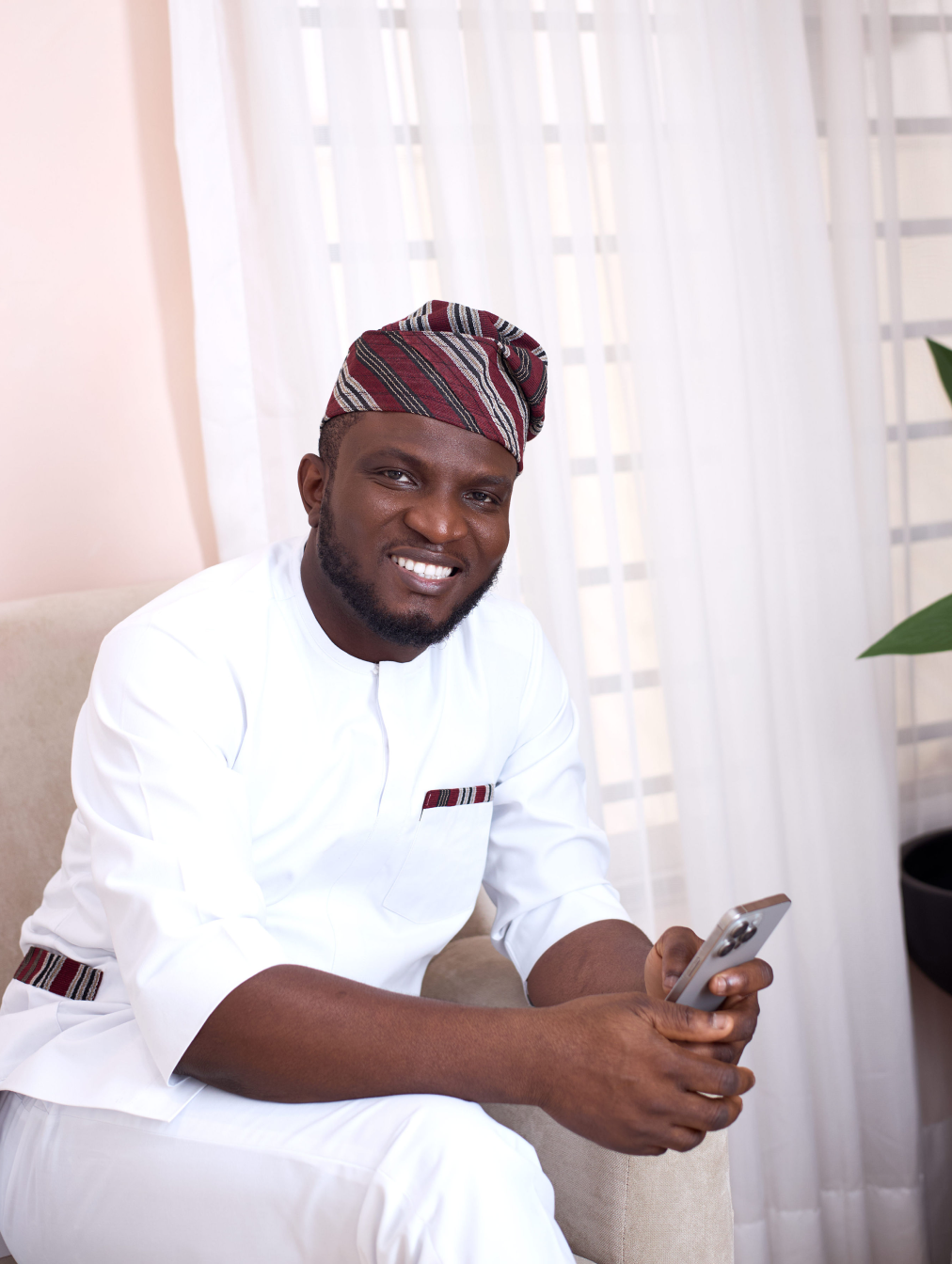 oed smiling while holding an iphone